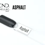Le visuel met en avant la capsule du vernis semi-permanent CND™ Shellac Asphalt, dévoilant un gris anthracite profond et brillant, à la finition miroir élégante et homogène.
