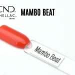 Le visuel montre la capsule du vernis CND™ Shellac Mambo Beat, orange corail intense et brillant à la finition crème.