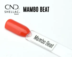 Le visuel montre la capsule du vernis CND™ Shellac Mambo Beat, orange corail intense et brillant à la finition crème.