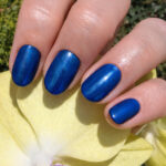 Vernis semi-permanent CND Shellac Peacock Plume bleu intense irisé appliqué sur ongles finition brillante