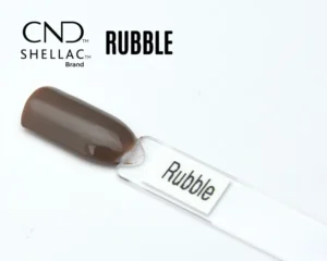 Le visuel montre la capsule du vernis CND™ Shellac Rubble, brun taupe profond et brillant, finition crème homogène.