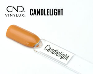 Capsule du vernis CND™ VINYLUX™ Candlelight – orangé ambre opaque, finition crème.