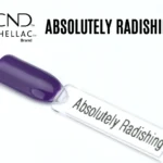Le visuel met en avant la capsule du vernis semi-permanent CND™ Shellac Absolutely Radishing, révélant sa teinte violet framboise éclatante, lumineuse et sa finition ultra brillante effet miroir.