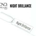 Capsule du vernis semi-permanent professionnel CND™ Shellac Night Brilliance, blanc argenté scintillant aux reflets nacrés et effet givré.