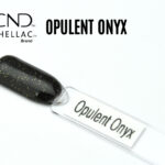 Capsule du vernis semi-permanent professionnel CND™ Shellac Opulent Onyx, noir profond parsemé de fines paillettes dorées au fini brillant et luxueux.